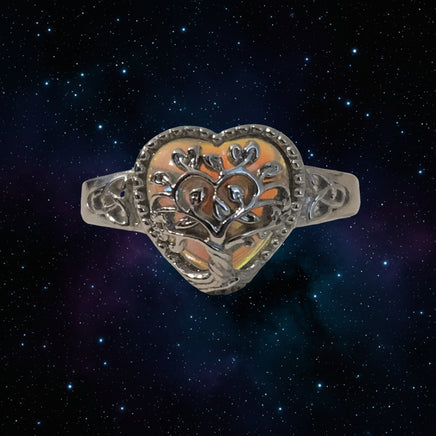 Silver ring with intricate design on a white background
