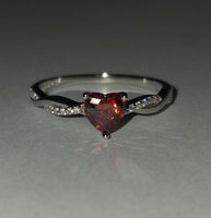 Crimson Twist red CZ heart ring – dark background