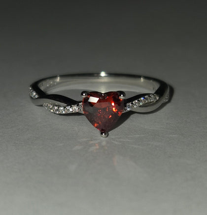 Crimson Twist red CZ heart ring – dark background