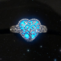 Silver ring with blue gemstone on a black background