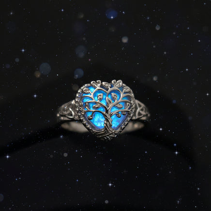 Silver ring with blue gemstone on a black background